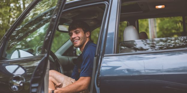 man looking at vin in car