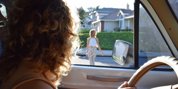 girl driving old car