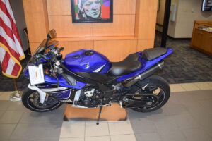 repossessed motorcycle for sale parked inside a bank lobby