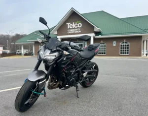 repossessed motorbike for sale in front of a credit union
