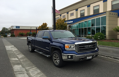 Truck for sale at a bank showing repo cars are cheaper when sold direct